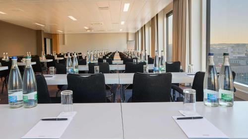 a conference room with tables and chairs with bottles on them at Radisson Blu Hotel Zurich Airport in Kloten