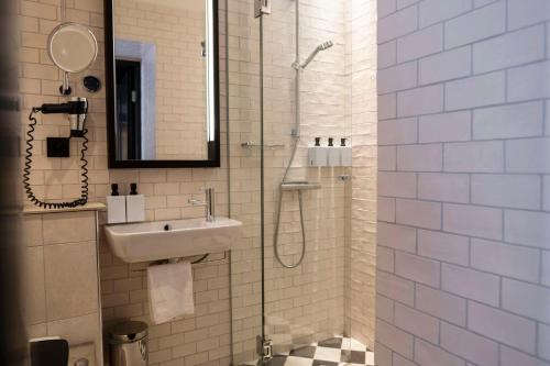 a bathroom with a sink and a shower at Scandic Grand Central in Stockholm