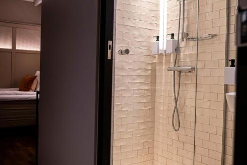 a shower in a bathroom with a glass door at Scandic Grand Central in Stockholm