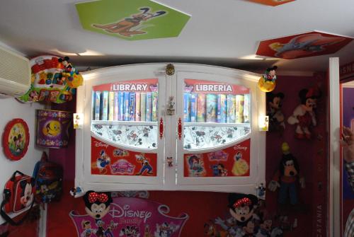 a room with a cabinet filled with dvds at DISNEY FAMILY Airport Catania City in CTA
