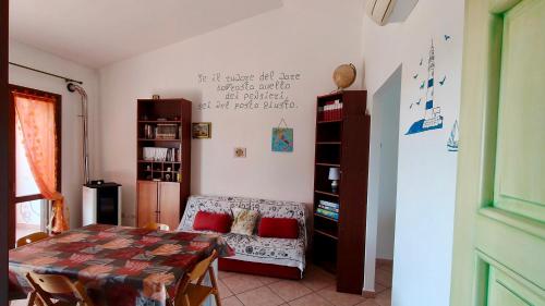 a living room with a table and a couch at Zurrundeddu House in Pula