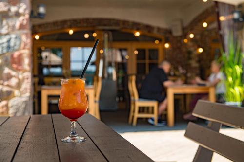 a drink is sitting on a wooden table at Porto Resort in Lilaste