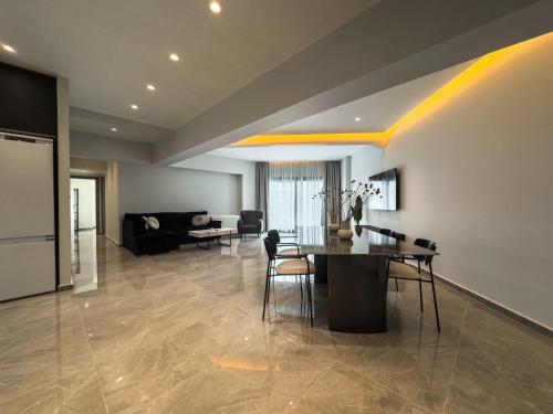 a living room with a table and a couch at VILLA 8 By ProLiving Hospitality in Thessaloniki