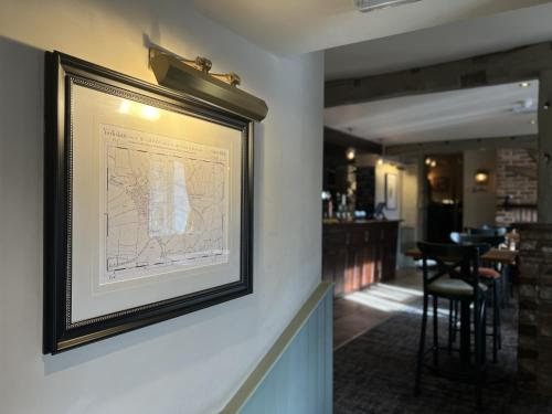 a framed map hanging on a wall in a restaurant at The Forresters Arms Kilburn in Kilburn
