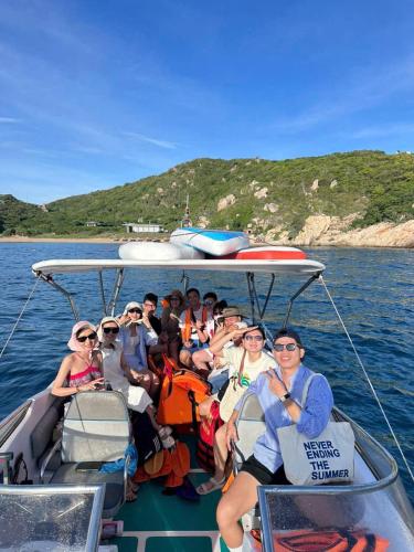 a group of people on a boat in the water at Hồng Tranquil Homestay Vĩnh Hy in Ninh Hải
