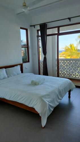 a bedroom with a large bed with a view of the ocean at Sultan Palace in Mombasa