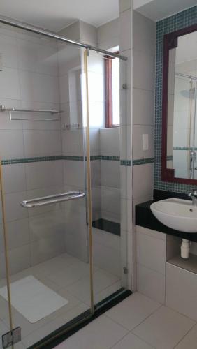 a bathroom with a glass shower and a sink at Sultan Palace in Mombasa