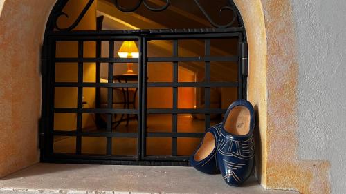 a pair of shoes standing in front of a door at Hotel Berghof in Zermatt