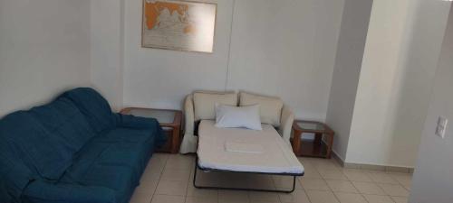 a living room with two chairs and a couch at Captain's Lodge in Ermoupoli