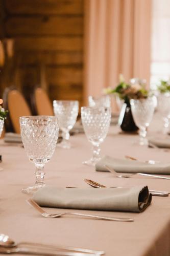 a table with wine glasses and napkins on it at Porto Resort in Lilaste