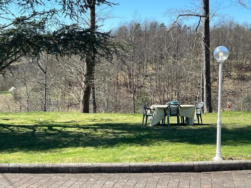 a table and chairs in a park with a street light at Casa del Sindaco in Giusvalla