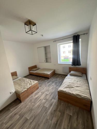 a room with two beds and a window at Dream Home in Szentes