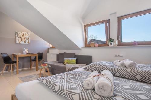 a bedroom with two beds with towels on them at Bergchalet Mirabell - Hofgut in Friedrichshafen