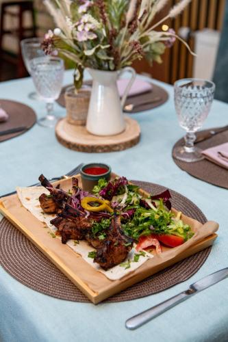 a plate of food sitting on top of a table at Porto Resort in Lilaste