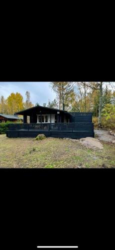 a house that is sitting in a yard at Hirsimökki,Meri,Sauna,Terassi in Kustavi