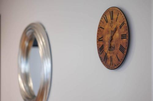 a clock hanging on a wall next to a ring at St. Edwards Overlook in Sligo