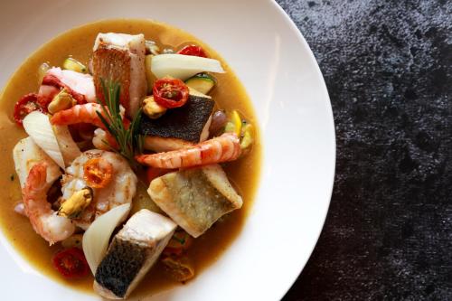 a white plate of food with shrimp and other foods at Hotel - Restaurant Le Cerf & Spa in Marlenheim