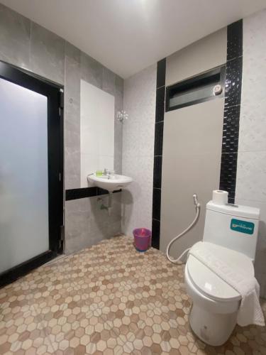 a bathroom with a toilet and a sink at The Coco Grand Chalet in Satun