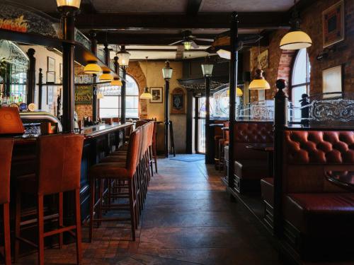 a bar with leather seats in a restaurant at Hotel Reja, a Member of Design Hotels in Klaipėda