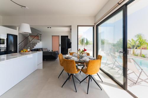 a kitchen and dining room with a table and chairs at Blue Hills Villa in Kallithea Rhodes