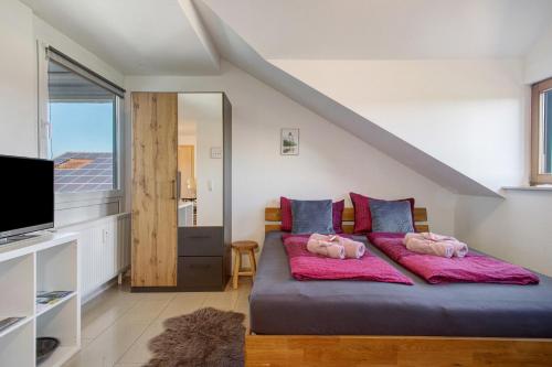 two pigs laying on a bed in a room at Bergchalet Mirabell - Hofgut in Friedrichshafen