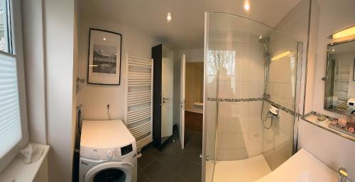 a bathroom with a shower and a toilet and a sink at Hering in Scharbeutz
