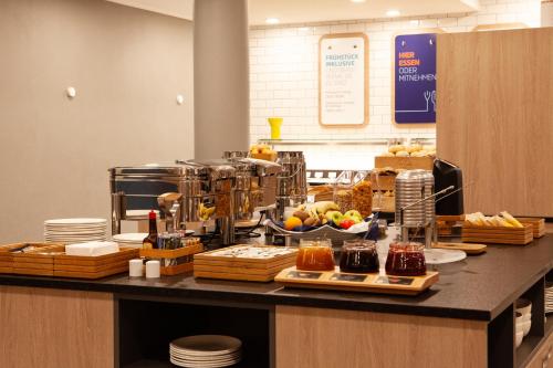 a buffet line with various food items on a counter at Holiday Inn Express Neunkirchen by IHG in Neunkirchen