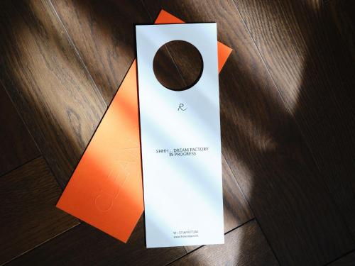 an orange and white bag with a chocolate in it at Hotel Reja, a Member of Design Hotels in Klaipėda
