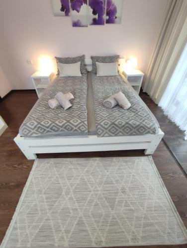 a bedroom with a bed with two pillows on it at Карпатська Вершина in Yaremche