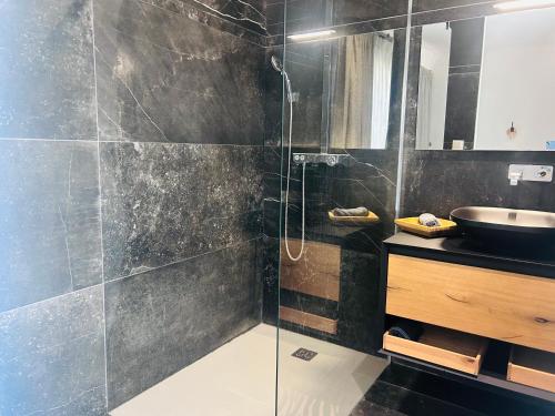 a bathroom with a glass shower and a sink at Maison T5 avec piscine T5chambres Annecy in Annecy