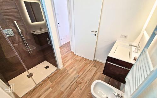 a bathroom with a shower and a sink and a toilet at HT - Luxury apartment at Palm Beach Jesolo in Lido di Jesolo