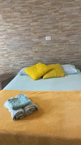 a bed with two blankets and two pillows on it at Biomas Hotel in Brotas