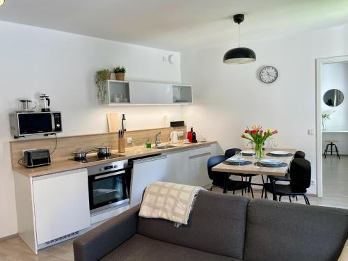 a kitchen and living room with a couch and a table at Lakepark Residence in Staré Splavy