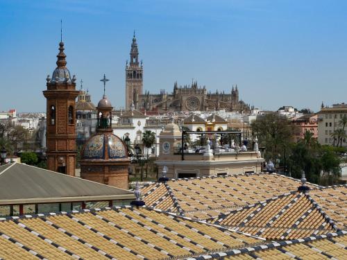 a view of a city from the roofs of buildings at Magno Apartments Altozano I in Seville