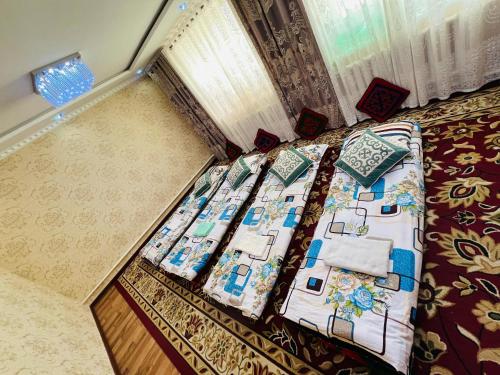 a bed with pillows on it in a bedroom at Oroz Guest House in Jangy-Talap
