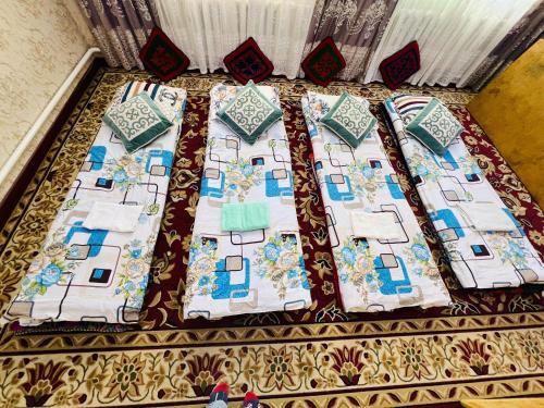 a table with a quilt on top of it at Oroz Guest House in Jangy-Talap