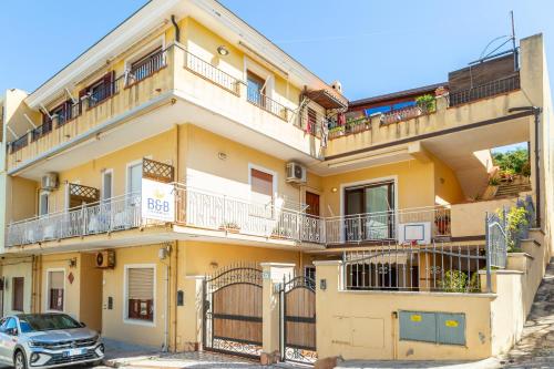a yellow building with a car parked in front of it at B&B Calamoresca in Àrbatax