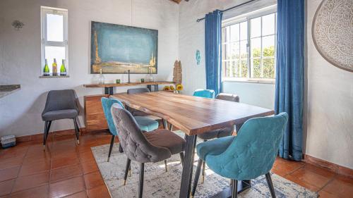 a dining room with a wooden table and chairs at 2 Vale de Ursa - Swimming Pool - WIFI - BY BEDZY in Guia