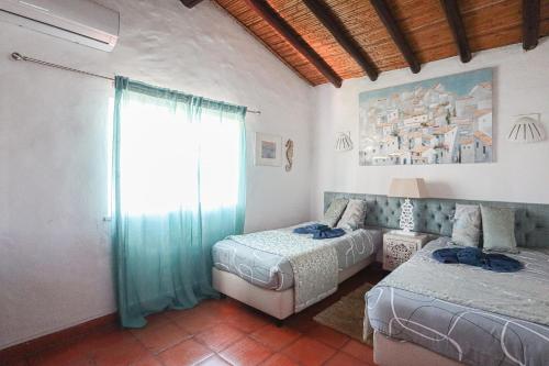 a bedroom with two beds and a window at 2 Vale de Ursa - Swimming Pool - WIFI - BY BEDZY in Guia