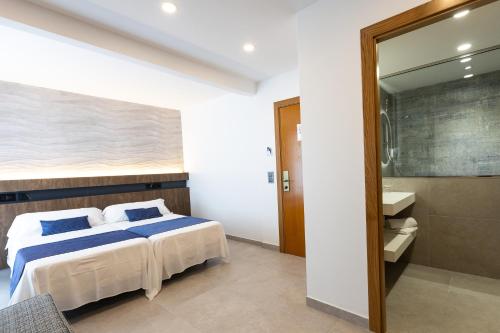 a bedroom with a bed and a large mirror at Hotel Internacional in Calella