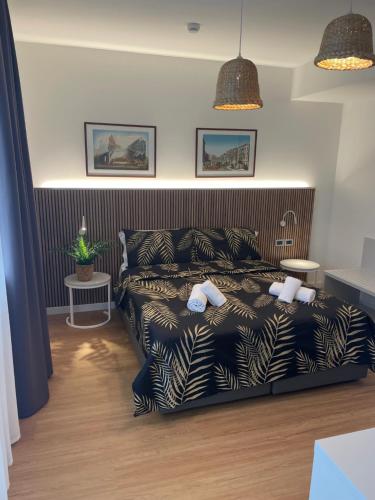 a bedroom with a bed with a black and white blanket at Hotel La Pergola di Venezia in Venice-Lido