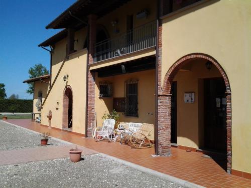 a house with two chairs and a patio at il Chiassetto Agriturismo No Kids in Cascina