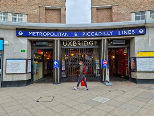 a man walking in front of a store at Uxbridge Suite in Uxbridge