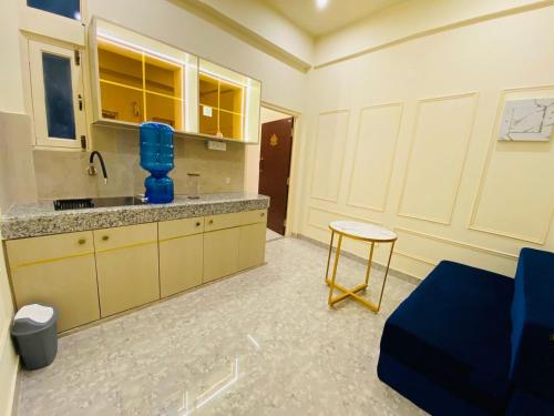 a kitchen with a sink and a stool in a room at Golden Lotus Varanasi in Varanasi