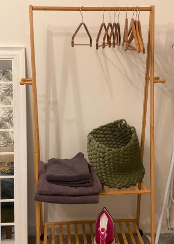 a room with a shelf with towels and hangers at Peterborough City Center Near Healthcare Center One Bed apartment With Free Private Parking Contractors Locum Staff welcome in Peterborough