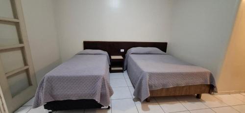 a room with two beds in a room at Hotel Plaza Olido in Sao Paulo