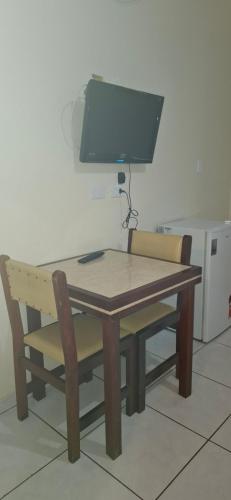 a wooden table and chair with a computer monitor on it at Hotel Plaza Olido in Sao Paulo