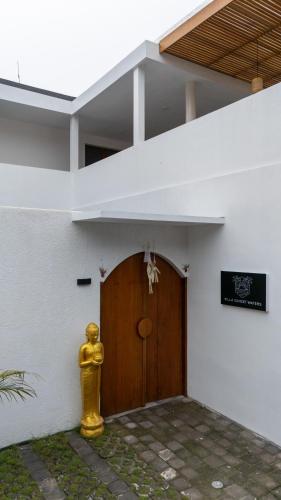 a yellow fire hydrant in front of a building at Villa Sunset Waters in Legian