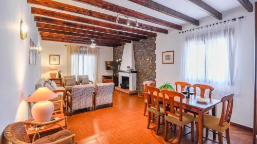 a living room with a wooden table and chairs at Casa Rural la Higuera de Rios Antequera - La Higuera by Ruralidays in Antequera