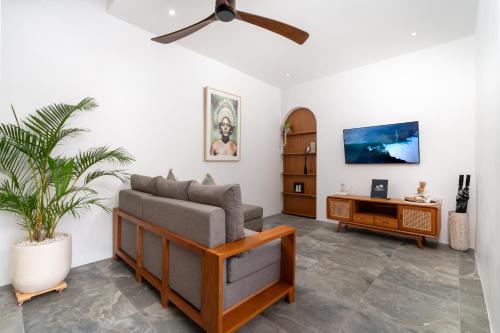 a living room with a couch and a table at Villa Sunset Waters in Legian